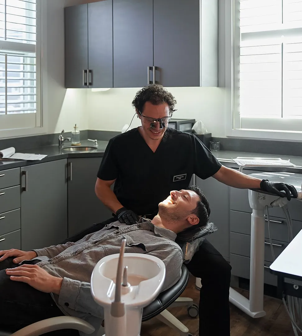 Dr. Nelson DeLima examining a patient at Red Bank Smiles in Red Bank, NJ