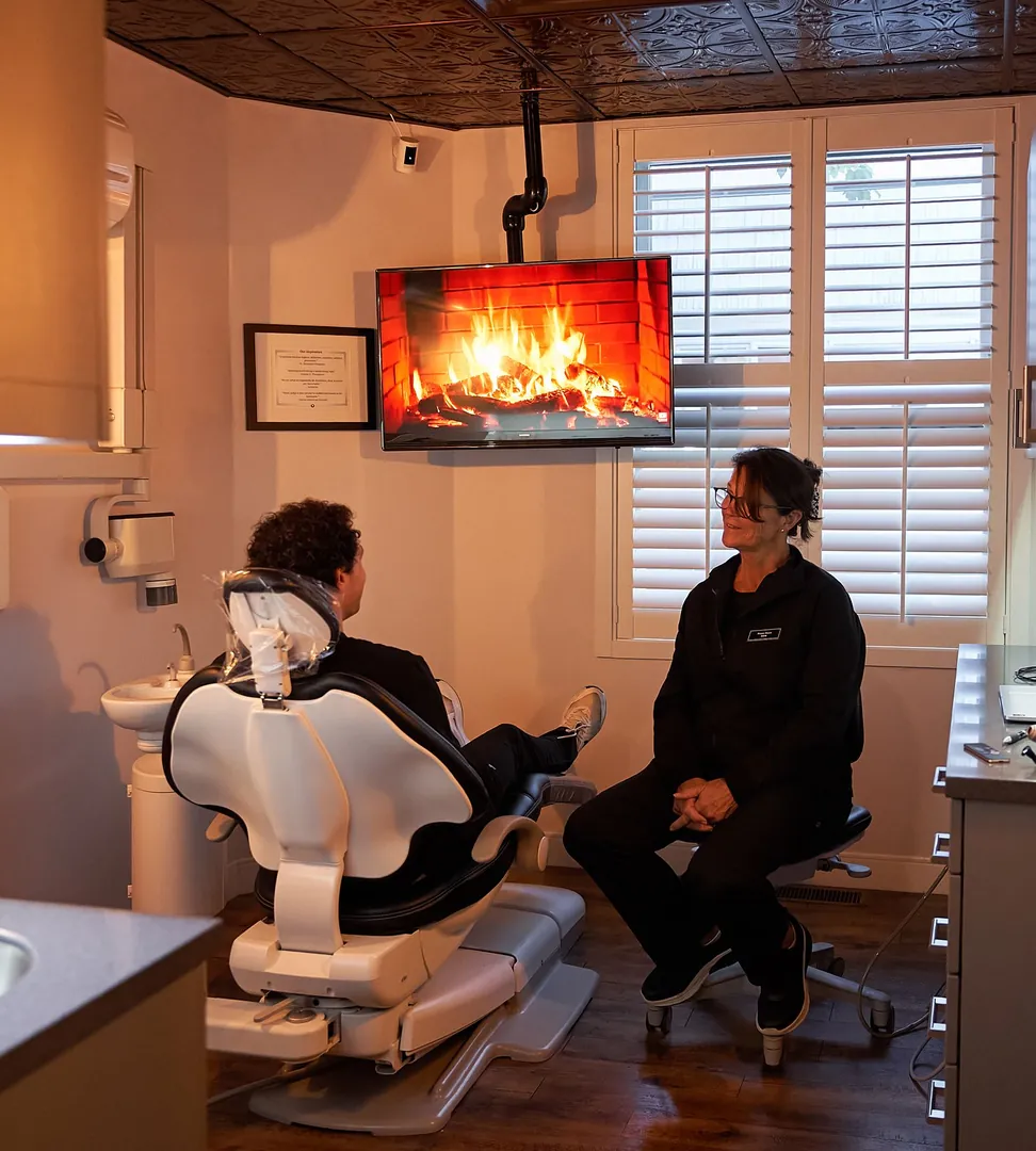 Dental hygienist Diane Davis talking with a patient at Red Bank Smiles in Red Bank, NJ