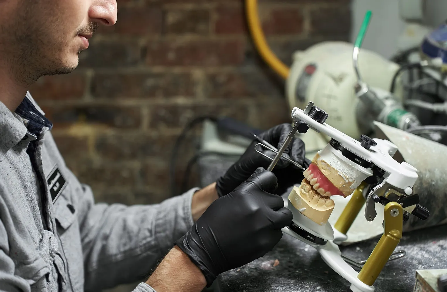 Michael working on a denture in the in-house dental lab at Red Bank Smiles in Red Bank, NJ